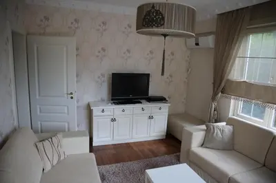 a living room with a couch and a tv at Damla Pansiyon in Sapanca
