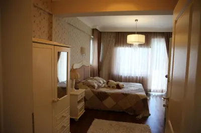 a bedroom with a bed with a teddy bear on it at Damla Pansiyon in Sapanca
