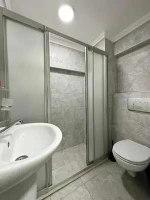a bathroom with a white sink and a toilet at Antik Ipek Suit in Istanbul