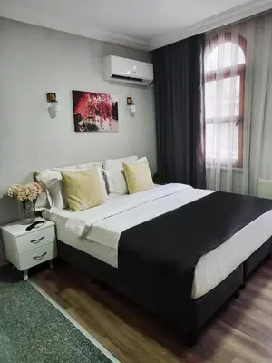a bedroom with a large bed and a window at Antik Ipek Suit in Istanbul
