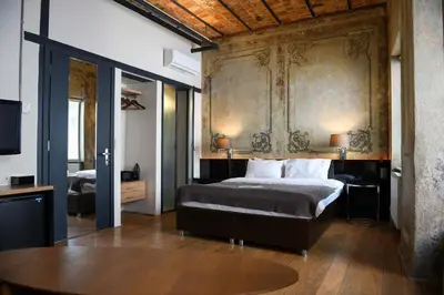 a bedroom with a bed and a table and a television at Taksim Galata Tower, Rooms Galata Historical Hotel in Istanbul