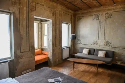 a living room with a couch and a table at Taksim Galata Tower, Rooms Galata Historical Hotel in Istanbul