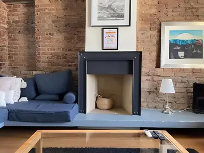 a living room with a blue couch and a fireplace at Taksim Galata Tower, Rooms Galata Historical Hotel in Istanbul