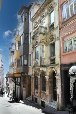 an old building on the side of a street at Taksim Galata Tower, Rooms Galata Historical Hotel in Istanbul