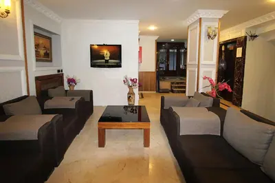 a living room with couches and a coffee table at Lyon Hotel İstanbul in Istanbul
