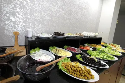 a buffet with many plates of food on a table at Lyon Hotel İstanbul in Istanbul