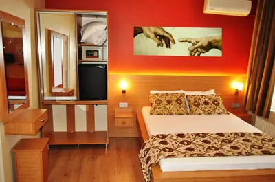 a bedroom with a bed and a red wall at Antique Hostel in Istanbul