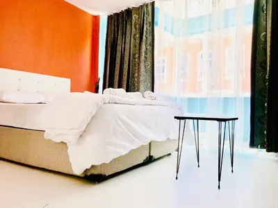 a bedroom with a bed and a table next to a window at Istanbul Harmony Hostel in Istanbul