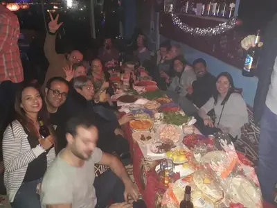 a group of people sitting around a long table with food at Istanbul Harmony Hostel in Istanbul