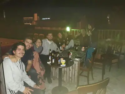 a group of people sitting around a table in a restaurant at Istanbul Harmony Hostel in Istanbul