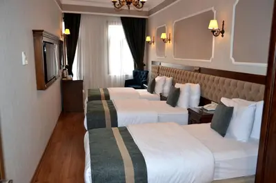 a hotel room with three beds in a room at Ahmet Efendi Konağı in Istanbul