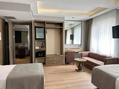 a hotel room with a bed and a couch at AHC Grand Bazaar Hotel in Istanbul