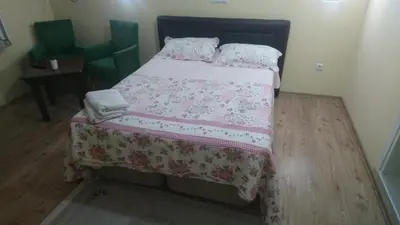 a bedroom with a bed with a blanket and pillows at Kumbaz Pansiyon in Sapanca