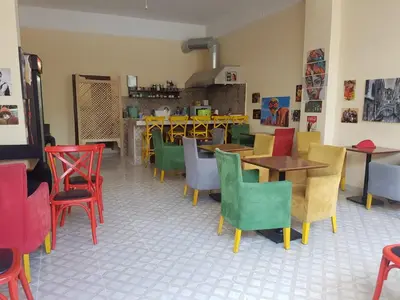 a restaurant with colorful chairs and tables in a room at Kumbaz Pansiyon in Sapanca