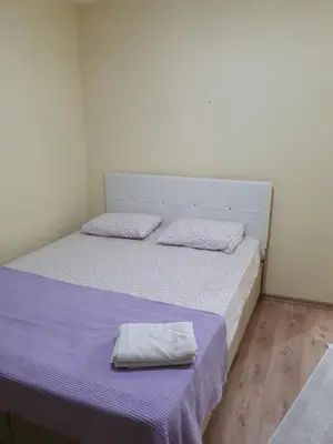 a bedroom with a bed with a pillow on it at Kumbaz Pansiyon in Sapanca