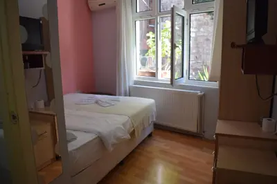 a small bedroom with a bed and a window at Sur Istanbul Hotel in Istanbul