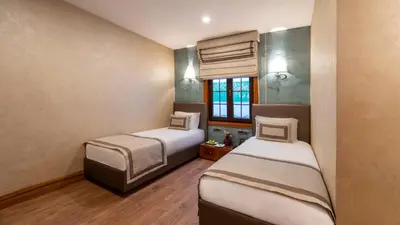 a room with two beds and a window at Biz Cevahir Hotel Sultanahmet in Istanbul
