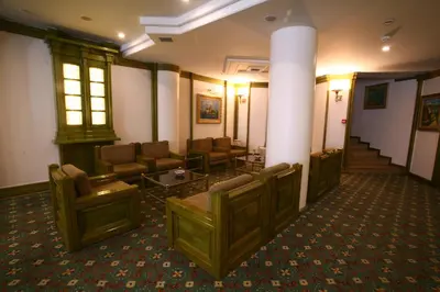 a lobby with a waiting room with chairs and tables at Istanbul Royal Hotel in Istanbul