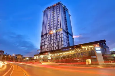 a tall building with lights in front of a street at TRYP by Wyndham Istanbul Basın Ekspres in Istanbul