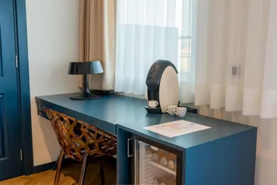 a blue desk with a iron and a lamp on it at Seminal Hotel Taksim in Istanbul