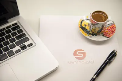 a cup of coffee sitting next to a laptop computer at Seminal Hotel Taksim in Istanbul