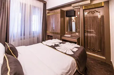 a hotel room with a large bed with towels on it at Dara Old City Hotel in Istanbul