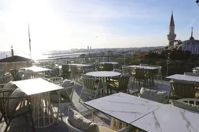 a patio with tables and chairs and a view of a city at Dara Old City Hotel in Istanbul