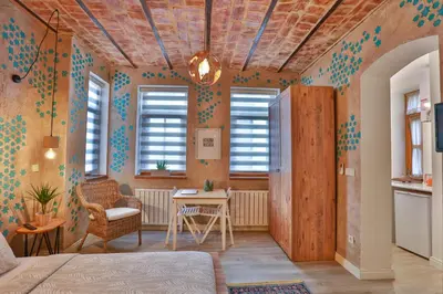 a room with a bed and a table and windows at Flats Company -Mujgan Apartment in Istanbul