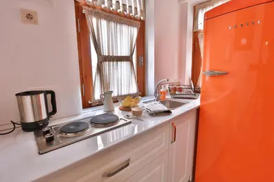 a kitchen with an orange refrigerator and a sink at Flats Company -Mujgan Apartment in Istanbul