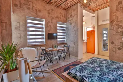 a room with a bed and a table and chairs at Flats Company -Mujgan Apartment in Istanbul
