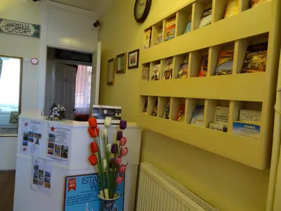 a kitchen with a refrigerator and a clock on a wall at Tulip Guesthouse in Istanbul