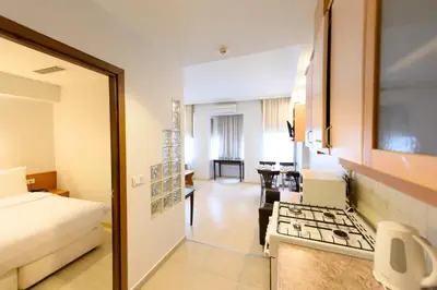 a hotel room with a bed and a kitchen at Entes Apart in Istanbul