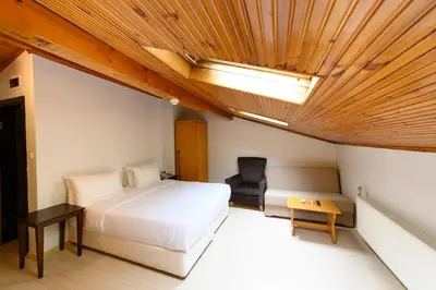 a bedroom with a bed and a chair in it at Entes Apart in Istanbul