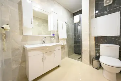 a bathroom with a white sink and a toilet at Entes Apart in Istanbul