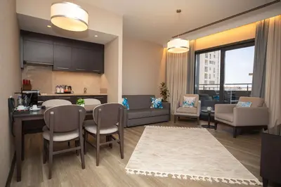 a kitchen and living room with a table and chairs at Park Inn by Radisson Istanbul Atasehir in Istanbul