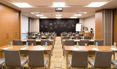 a room with tables and chairs and a chalkboard at Park Inn by Radisson Istanbul Atasehir in Istanbul