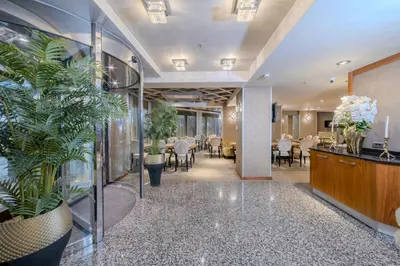 a lobby with potted plants and tables and chairs at Hotel Momento - Special Category in Istanbul