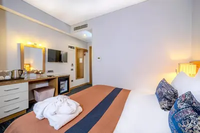 a bedroom with a bed with a desk and a mirror at Hotel Momento - Special Category in Istanbul
