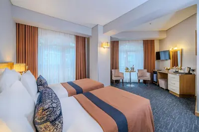 a hotel room with two beds and a desk at Hotel Momento - Special Category in Istanbul