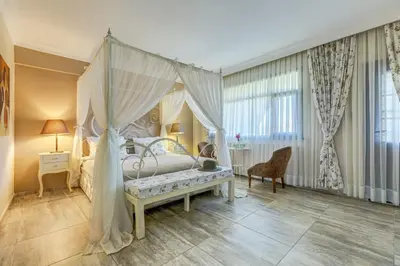 a bedroom with a canopy bed and a table at Agva Greenline Guesthouse (Adult Only +12) in Agva