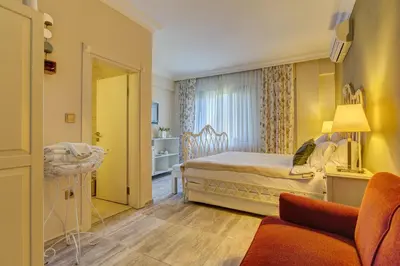 a bedroom with a bed and a living room at Agva Greenline Guesthouse (Adult Only +12) in Agva