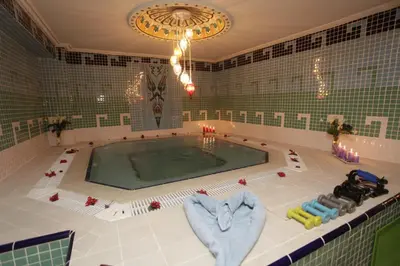 a swimming pool in a tiled room with at Marmaray Hotel in Istanbul
