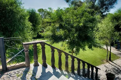 a staircase with a wrought iron railing and trees at Wineport Lodge Agva Riverside Hotel & Winery in Agva