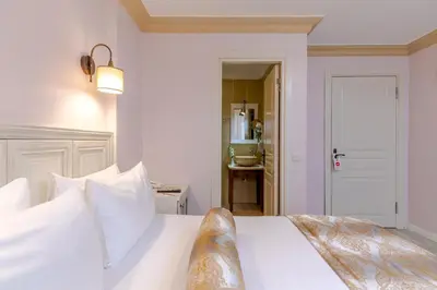 a bedroom with a white bed with white pillows at Agora Guesthouse in Istanbul