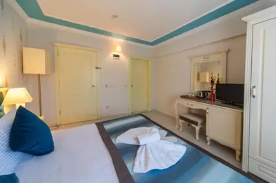 a bedroom with a bed and a desk and a computer at Viva Deluxe Hotel in Istanbul