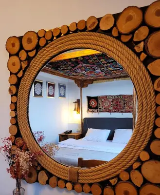 a bedroom with a bed with a round mirror at Marmara Guesthouse in Istanbul