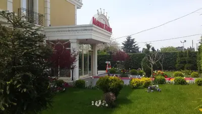 a house with a garden in front of it at Pendik Marine Hotel in Istanbul