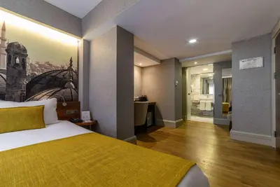 a hotel room with a bed and a bathroom at Ramada by Wyndham Istanbul Grand Bazaar in Istanbul