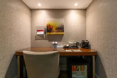 a room with a table and a chair in a room at Ramada by Wyndham Istanbul Grand Bazaar in Istanbul