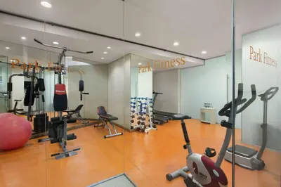 a gym with treadmills and exercise equipment and a mirror at Ramada by Wyndham Istanbul Grand Bazaar in Istanbul